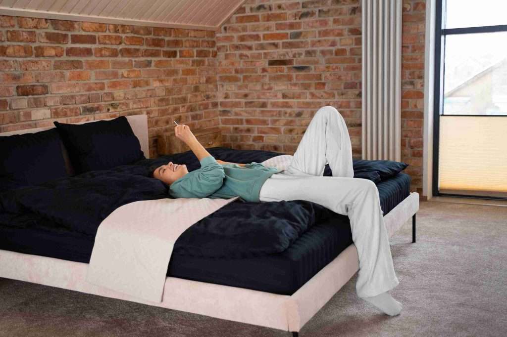 person using adjustable bed in bedroom