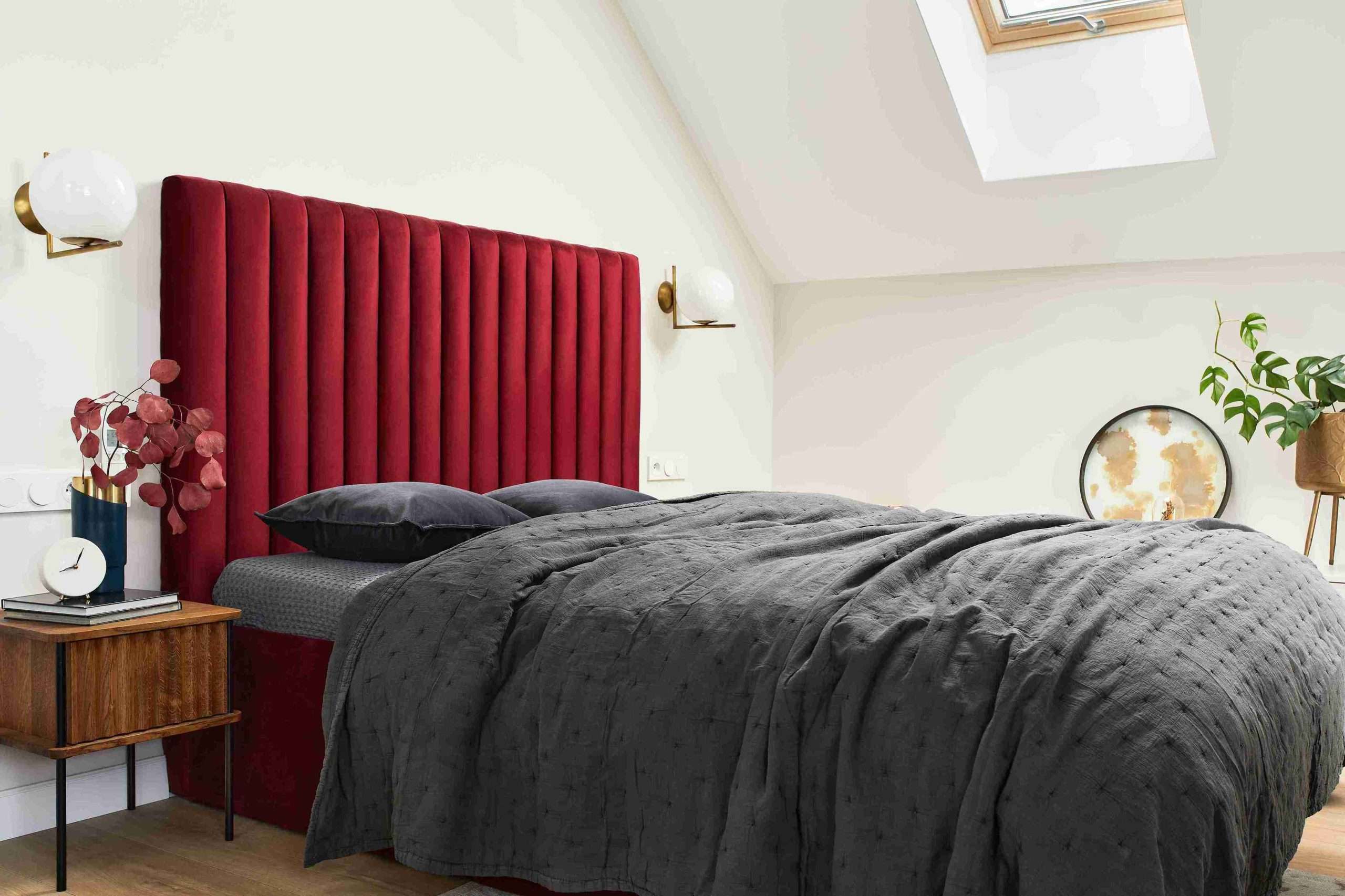bed with red upholstered headboard