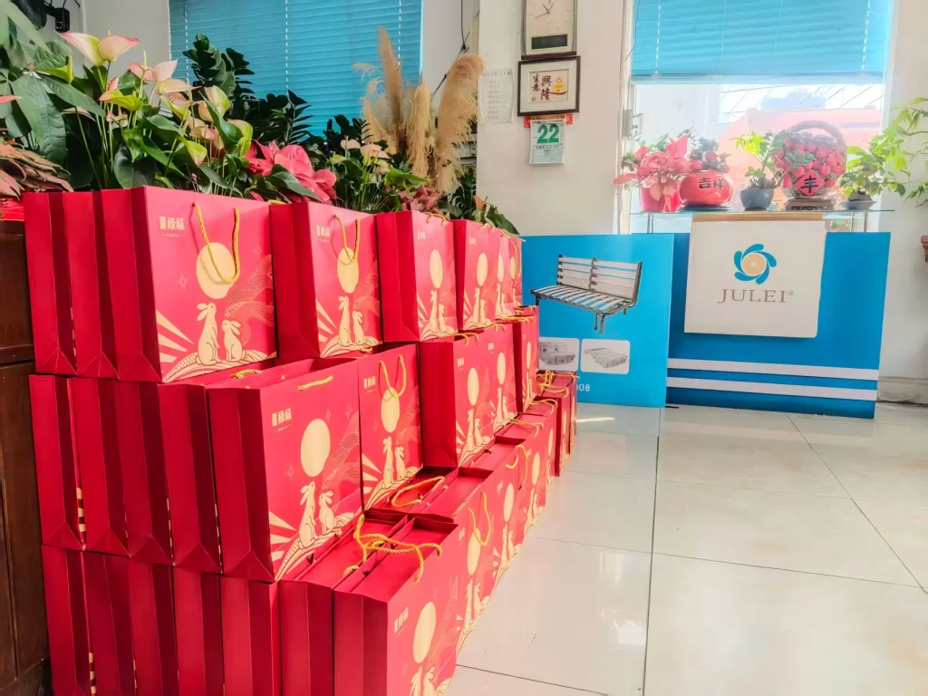 Mid-Autumn Festival mooncake gift bags stacked in company office lobby for employee distribution