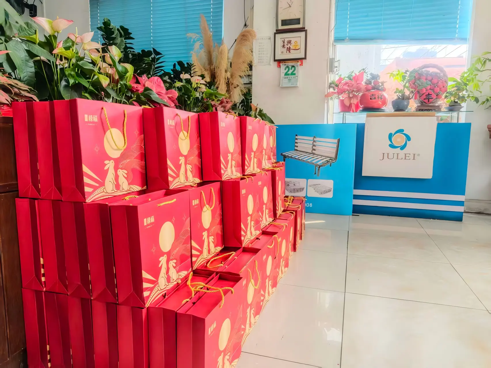 Mid-Autumn Festival mooncake gift bags stacked in company office lobby for employee distribution